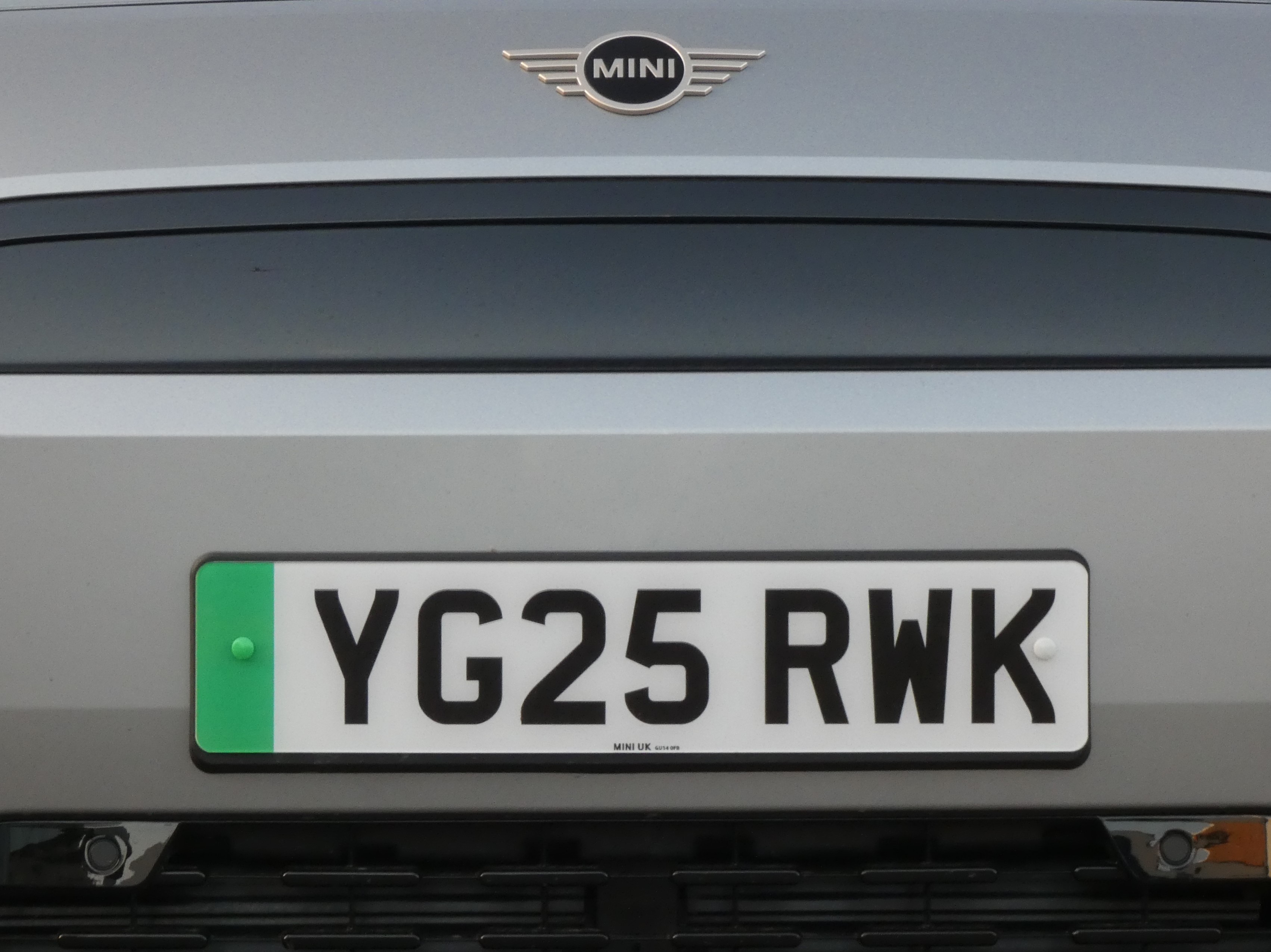 Close-up of a UK number plate on a car, photographed straight-on