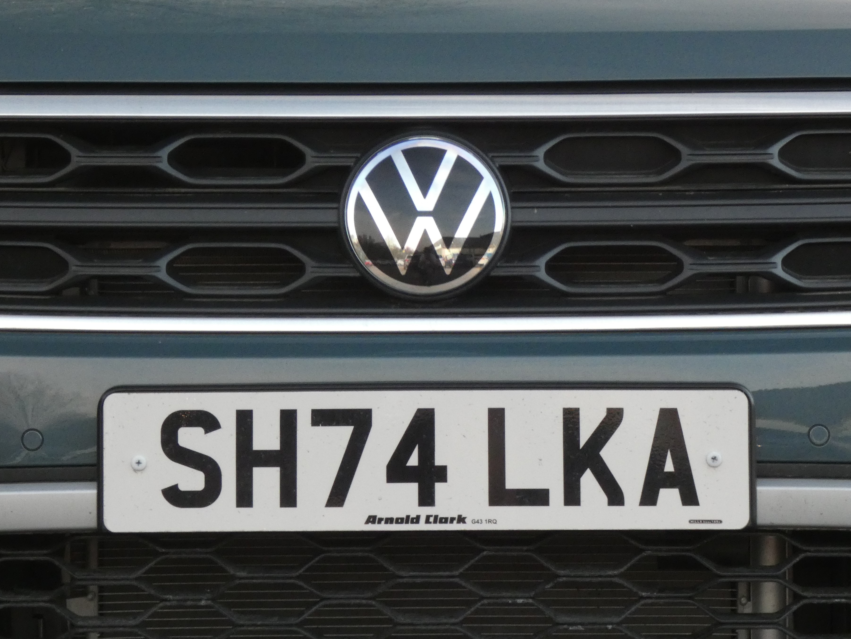 Front UK number plate mounted on the grille of a car